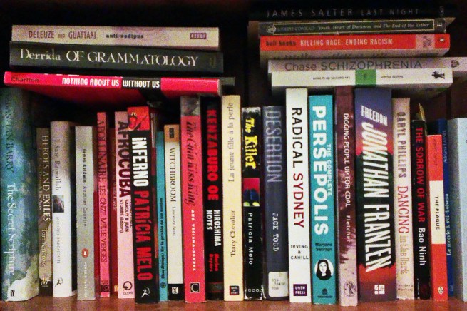 Image Description: Books on a bookshelf. Titles include Persepolis, Of Grammatology, Radical Sydney, AfroCuba