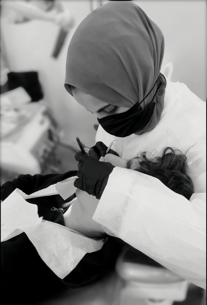 Dina doing dentistry on a young patient