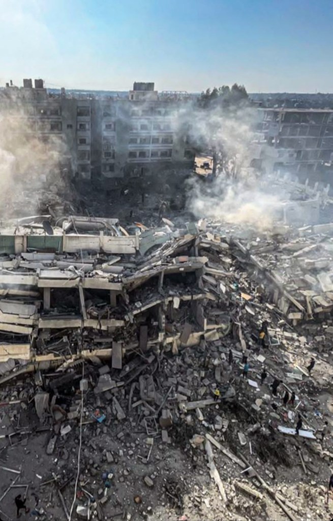 Dina's apartment building in ruins and smouldering the day after it was bombed.